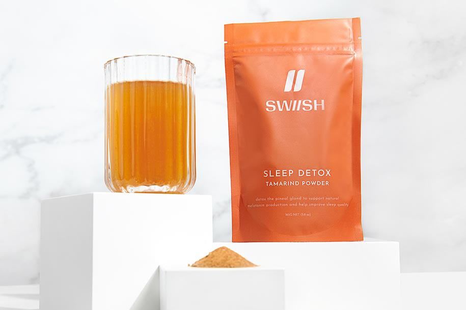 SWIISH Sleep Detox Tamarind Powder style styled with a glass and pile of the powder