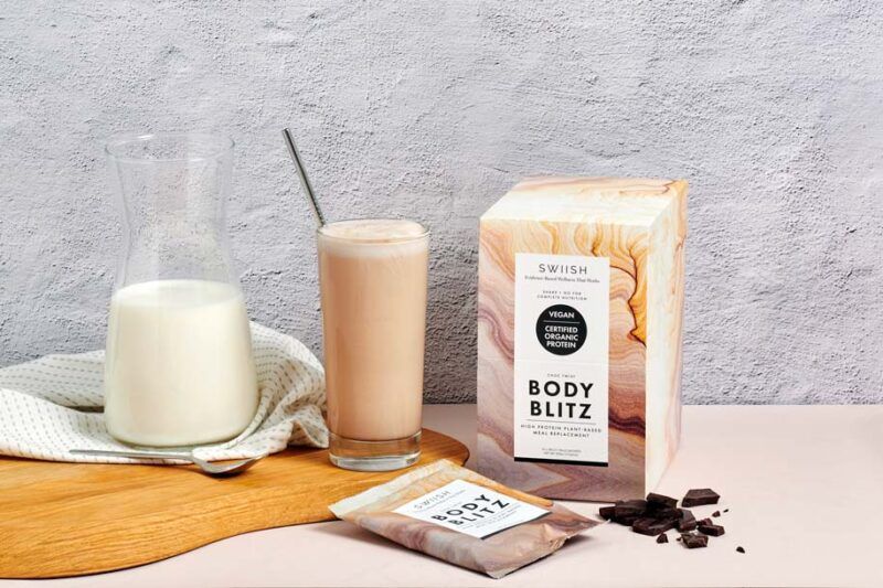 Body Blitz Protein Powder with drink and chocolate