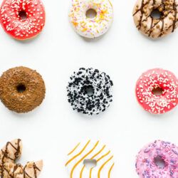 donuts with different toppings layed out